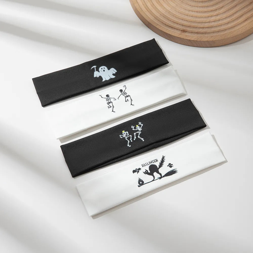 Spooky graphic headbands in black and white with ghost, skeleton, and black cat Halloween designs.