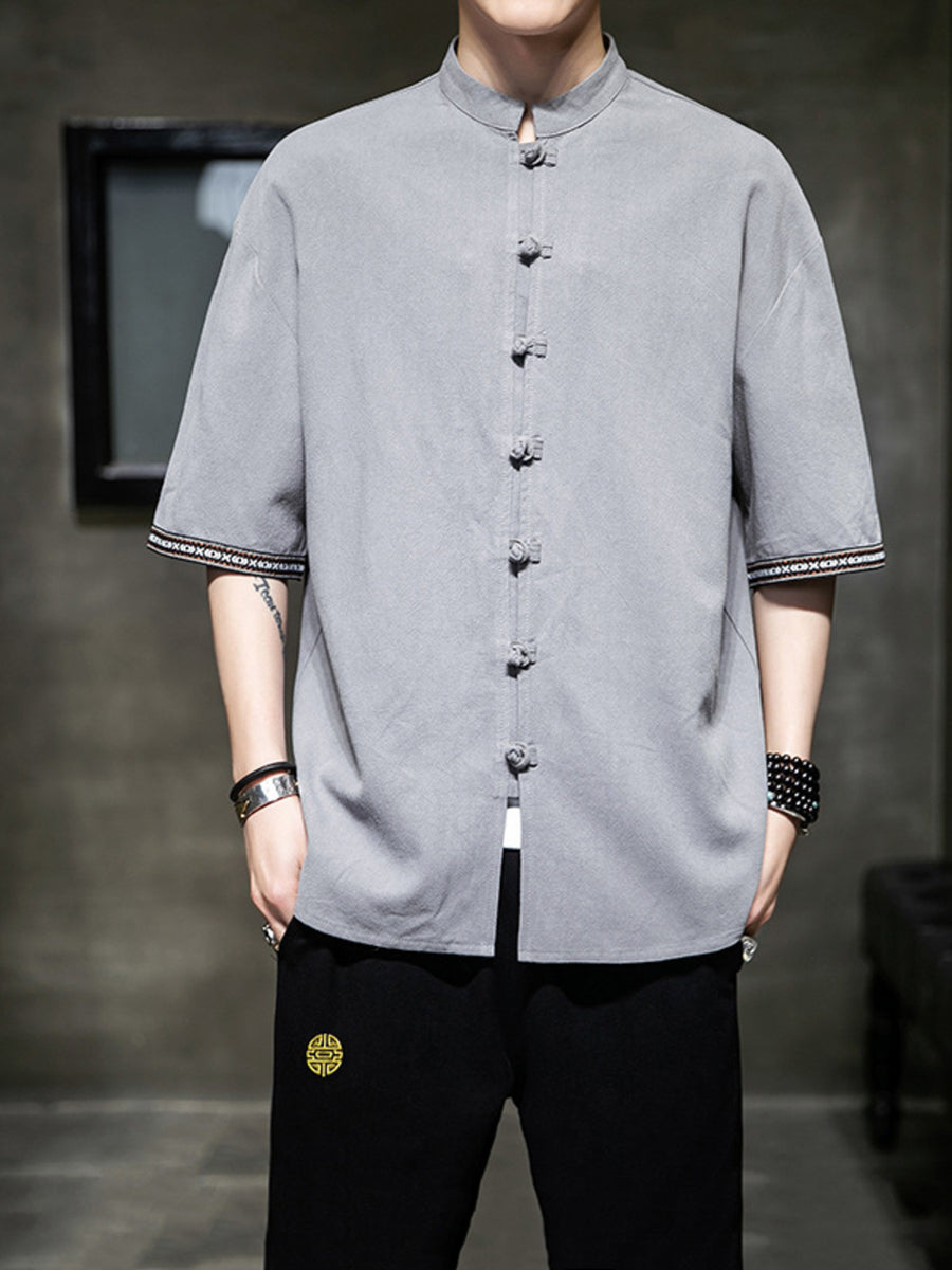 Grey cotton blend short sleeve mandarin collar shirt with frog button closure and embroidered cuffs.