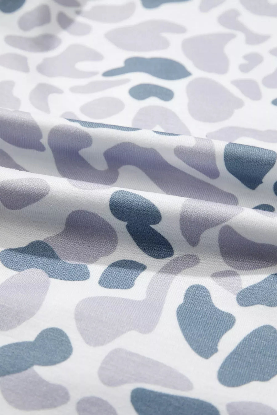 Camouflage print pajama fabric with blue and grey abstract shapes on white.