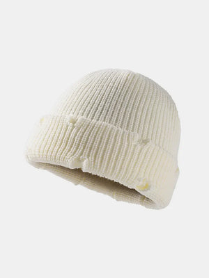 White ribbed knit beanie with distressed details and a cuffed hem.