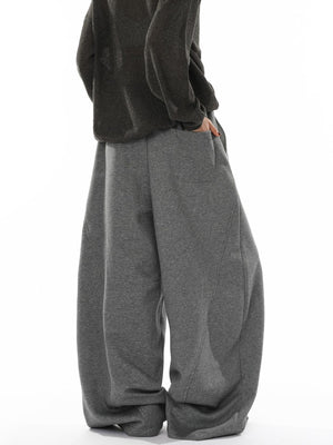 Men's gray wide-leg sweatpants with drawstring waist and pockets.