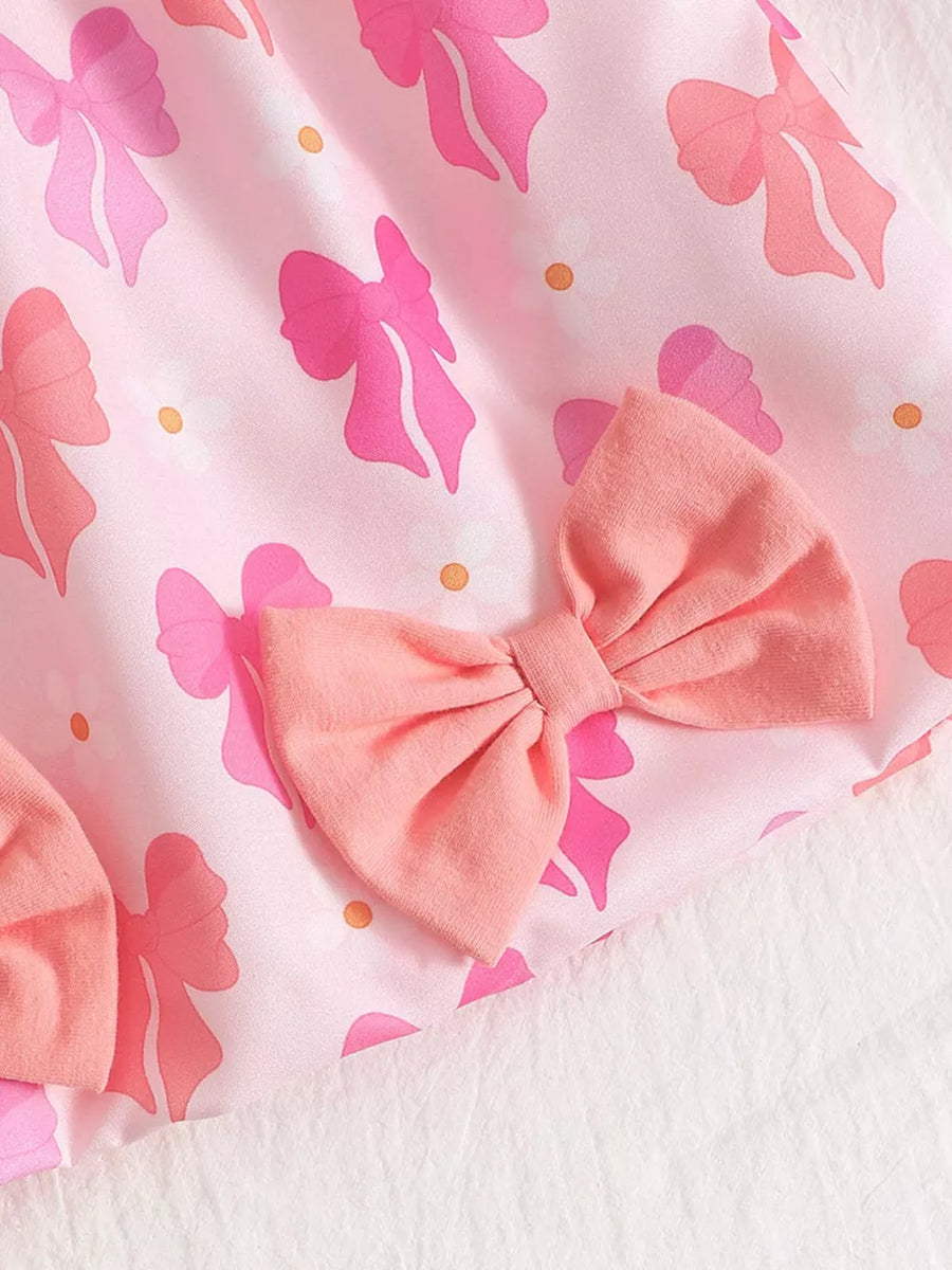 Pink baby dress with bow print and fabric bow embellishments