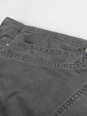 Men's grey cotton cargo capris with button closure and detailed stitching.