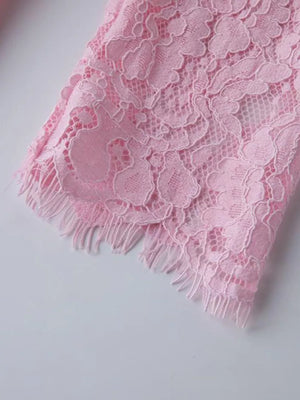 Pink lace midi dress detail showing sheer sleeves with fringed hem