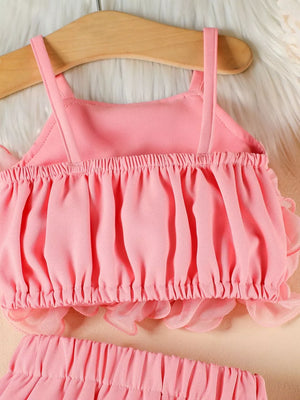 Pink ruffled cami and skirt set with delicate sheer trim.