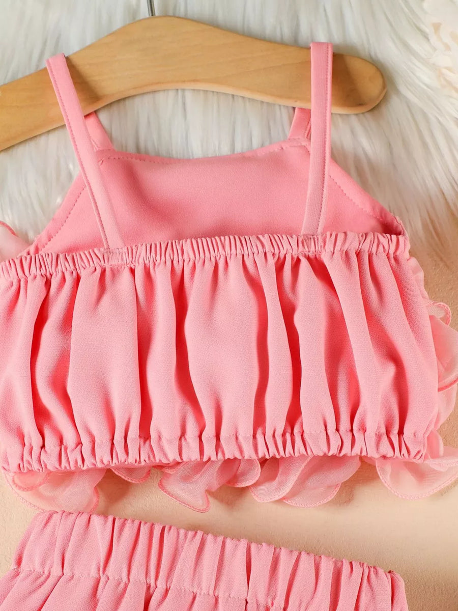Pink ruffled cami and skirt set with delicate sheer trim.