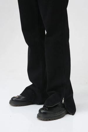 Flared hem denim trousers in dark cotton with zippered ankle detail.