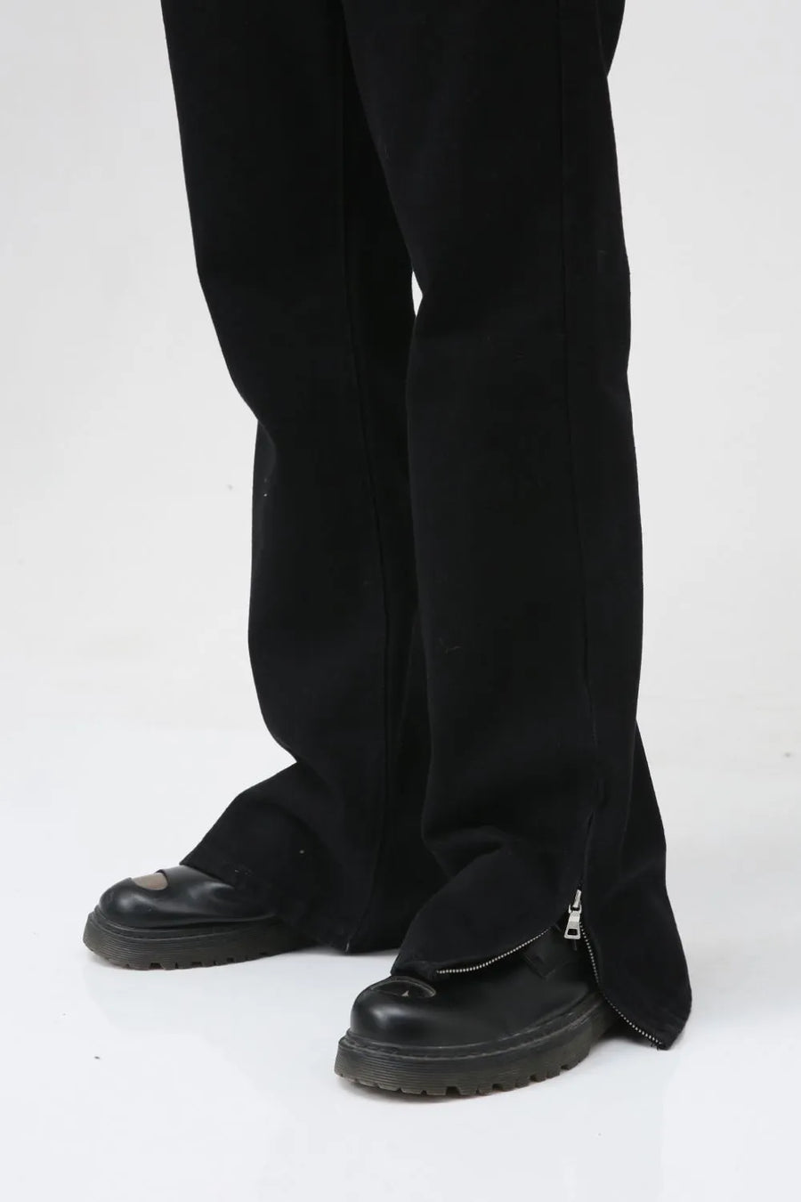 Flared hem denim trousers in dark cotton with zippered ankle detail.