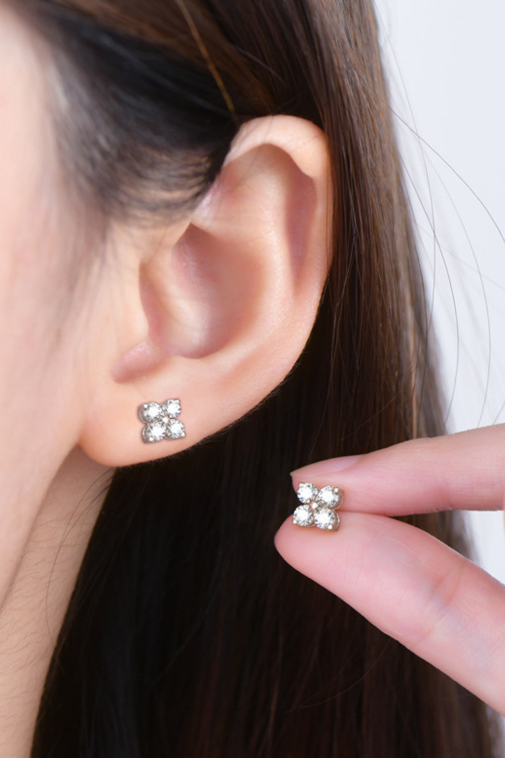 Four-stone stud earrings in sterling silver with four clear stones arranged in a square.