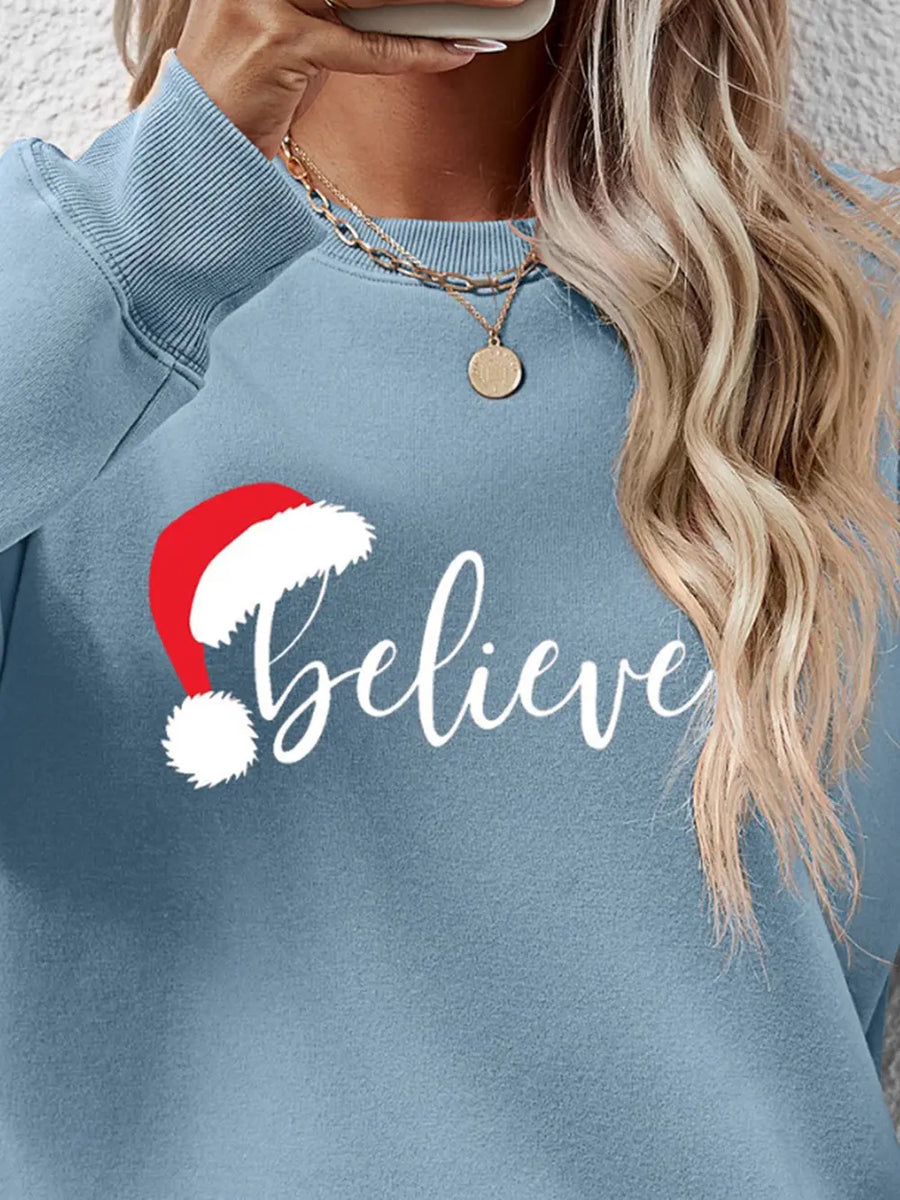 Light Blue raglan sweatshirt with "Believe" graphic and Santa hat detail.