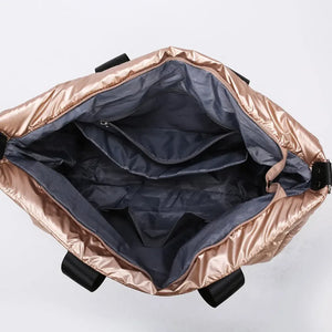 Glossy padded rose gold holdall showing interior pockets and compartments