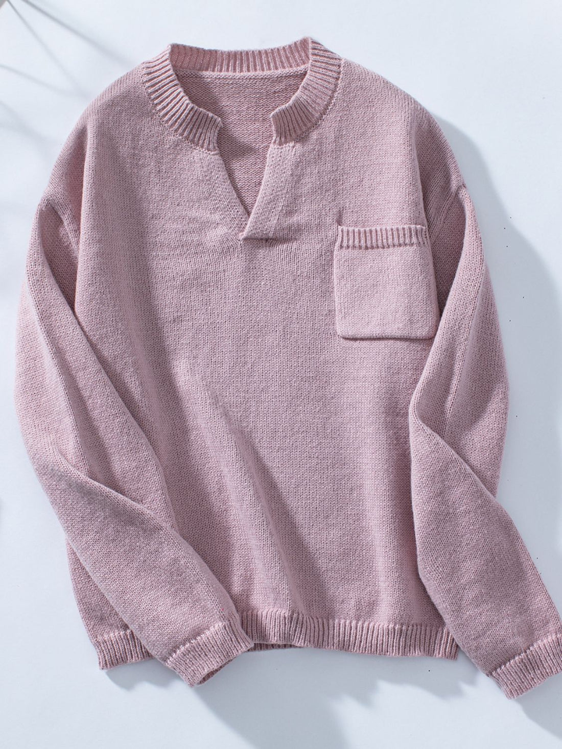 Dusty pink knit sweater with notched neckline and chest pocket.