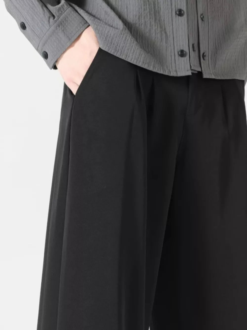 Men's black wide leg dress pants with pleats and side pockets.