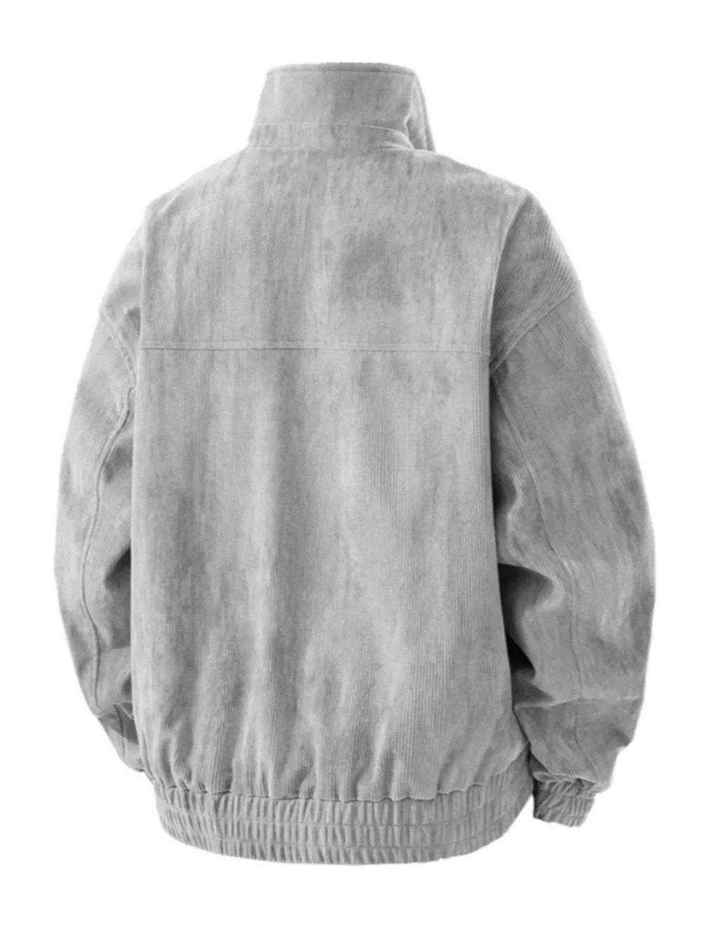 Grey corduroy trucker jacket with a stand-up collar and elasticated hem.