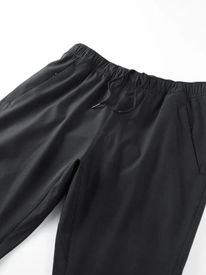 Black men's sweatpants with elastic waistband, drawstring, and side pockets.