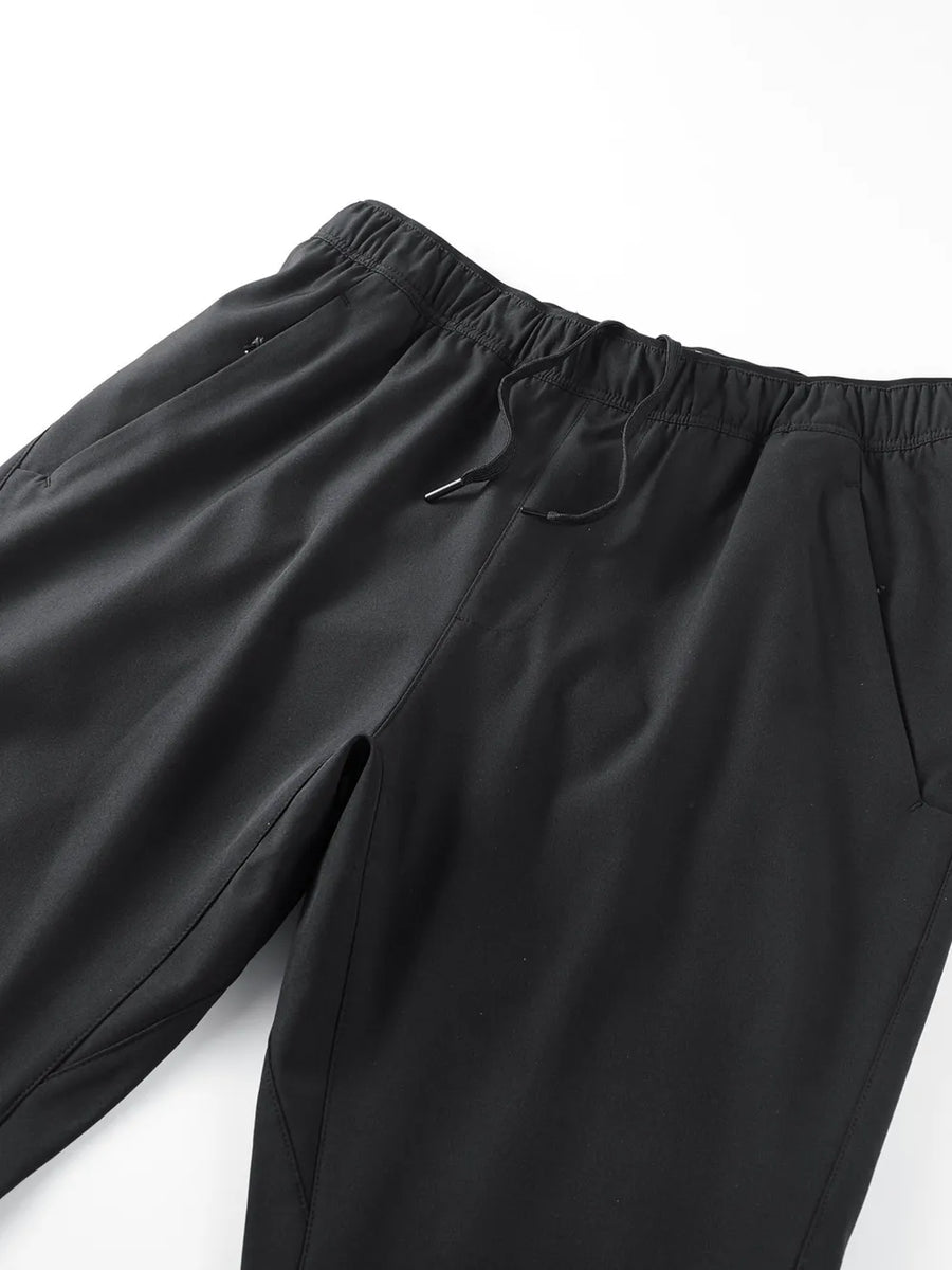 Black men's sweatpants with elastic waistband, drawstring, and side pockets.