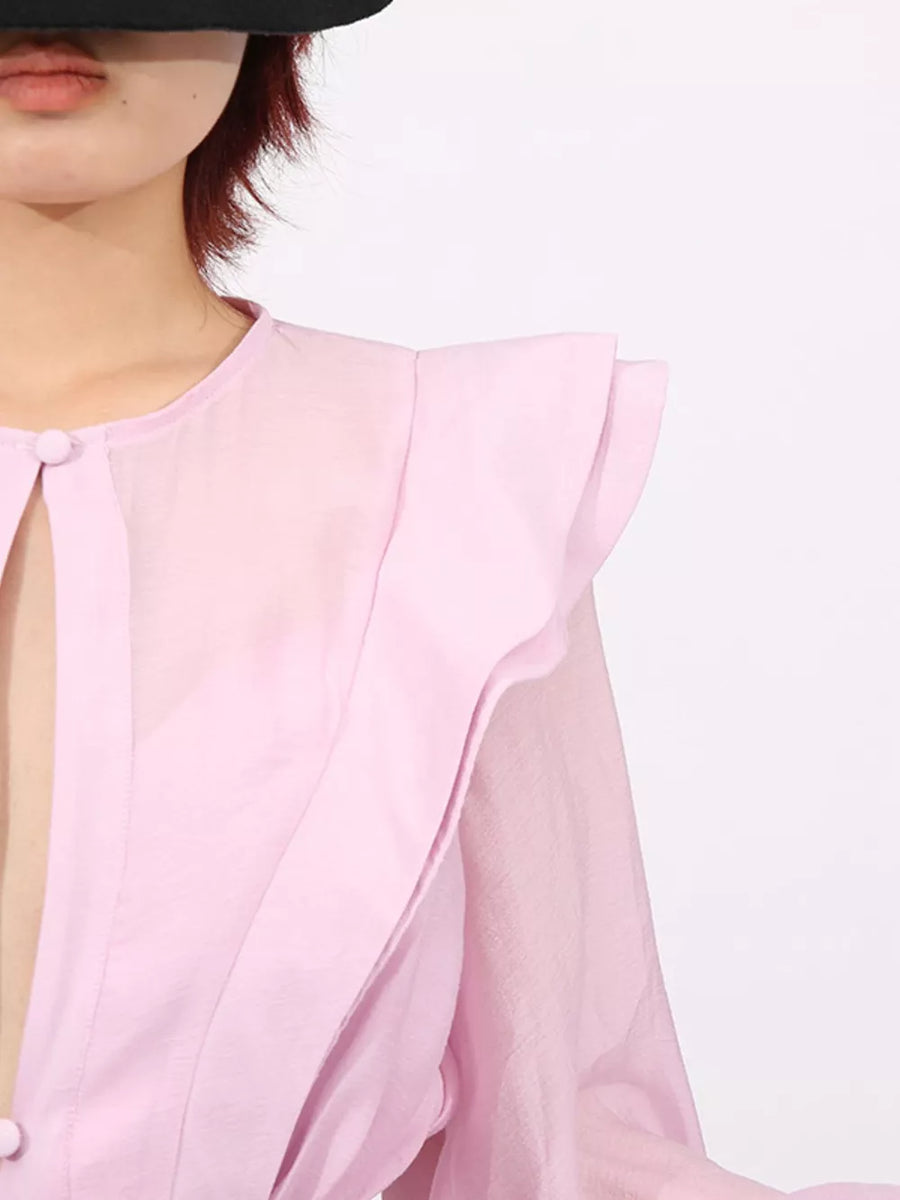 Pink tiered ruffle mini dress with button detail and sheer sleeves.
