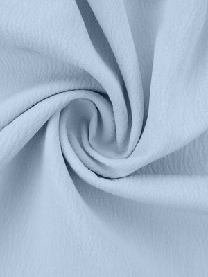 Light blue polyester pajama fabric with a ruffled texture.