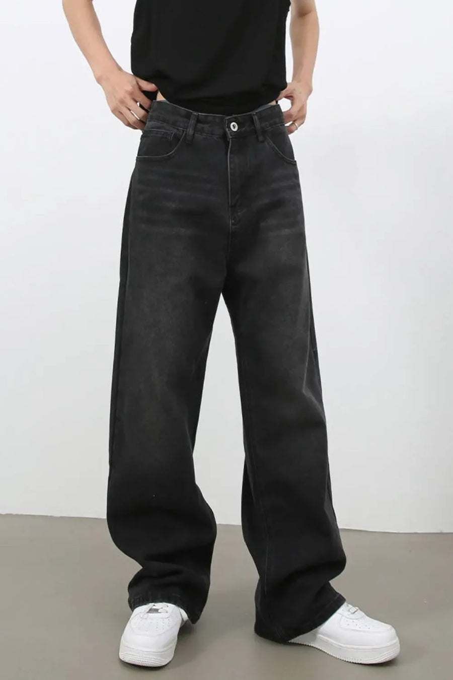 Black wide leg denim jeans with a relaxed fit and casual styling.