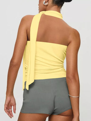 Yellow halter neck top with tie detail and grey shorts