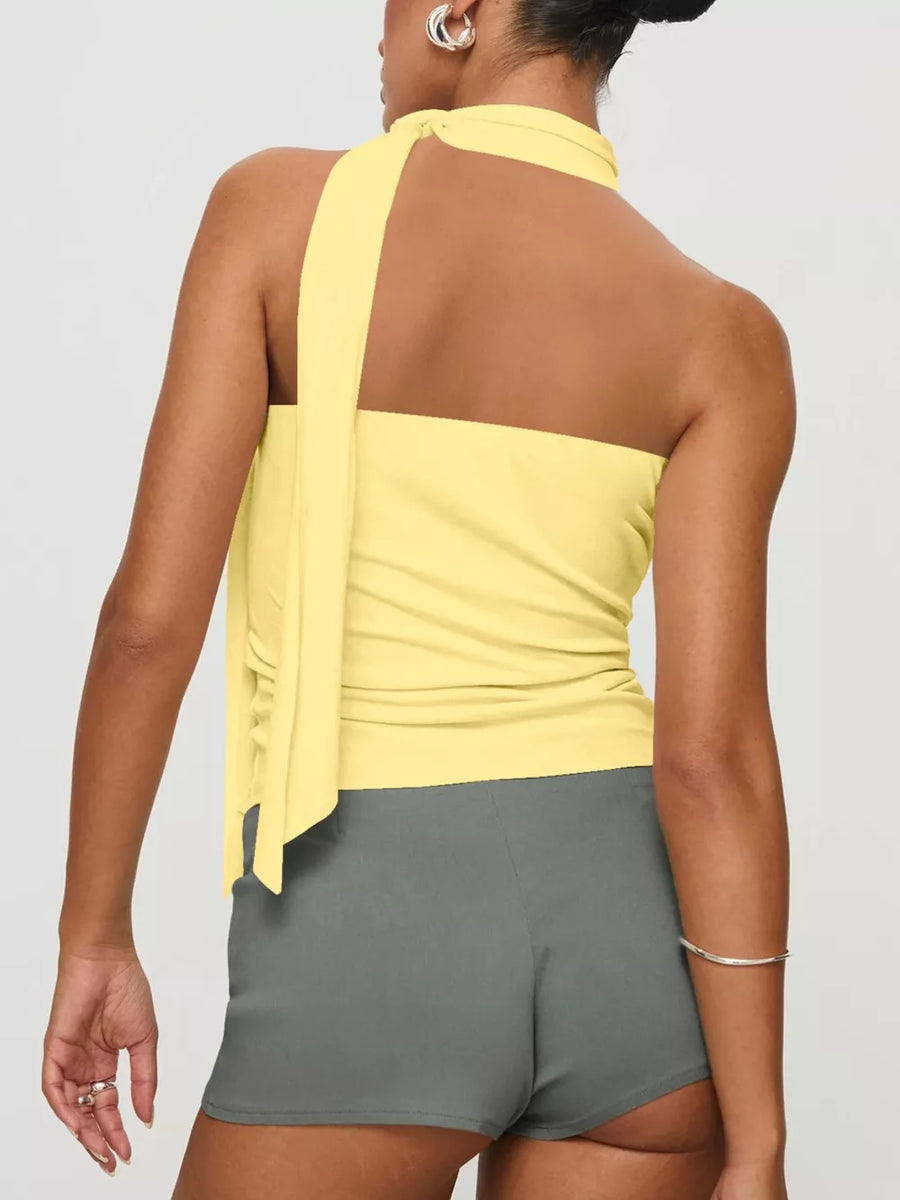 Yellow halter neck top with tie detail and grey shorts