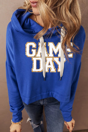 Royal blue cropped hoodie with glitter "GAME DAY" graphic and adjustable drawstring hood.