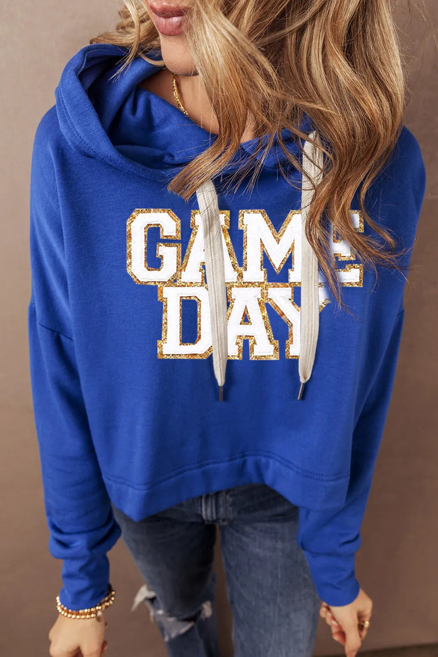 Royal blue cropped hoodie with glitter "GAME DAY" graphic and adjustable drawstring hood.