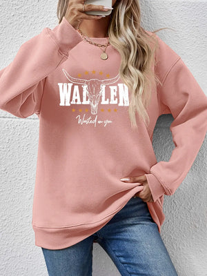 Blush pink drop shoulder sweatshirt with Western graphic and text detail.