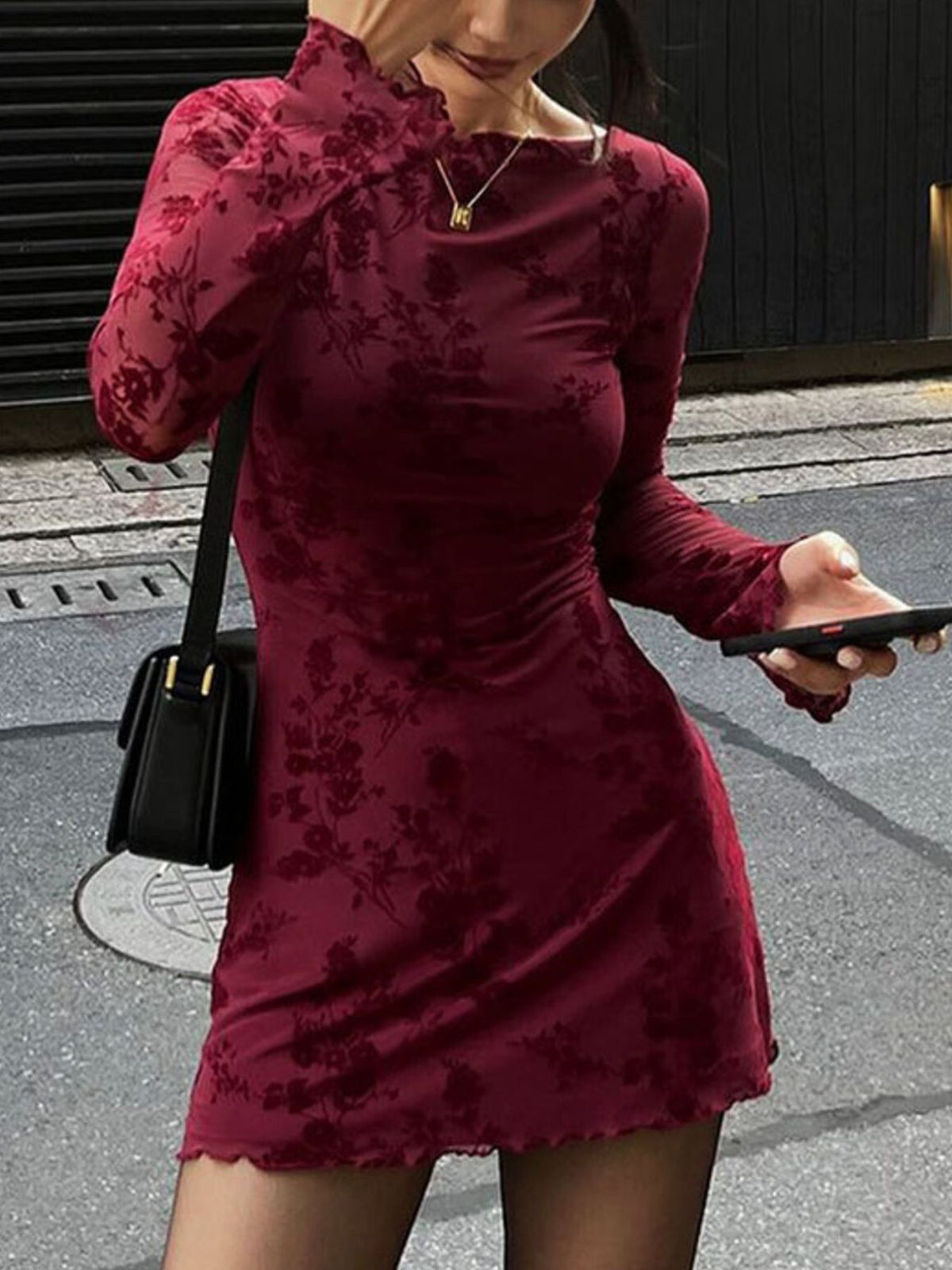 Burgundy floral mesh bodycon mini dress with long sleeves and lettuce hem.