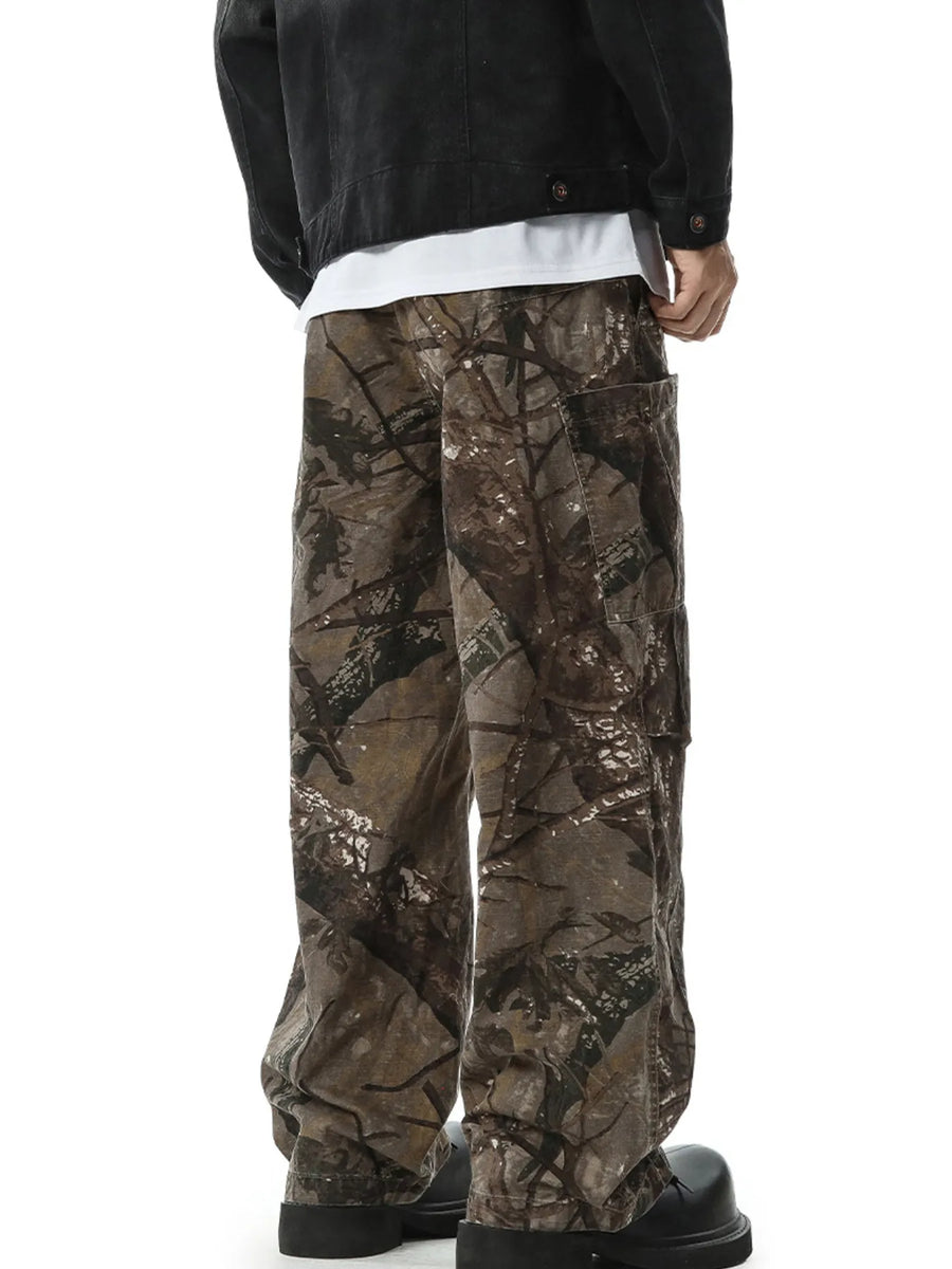 Relaxed fit cargo pants in camouflage pattern with multiple pockets.