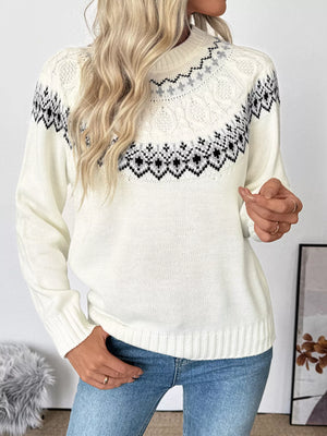 White Fair Isle knit sweater with a mock neck and cable knit details.