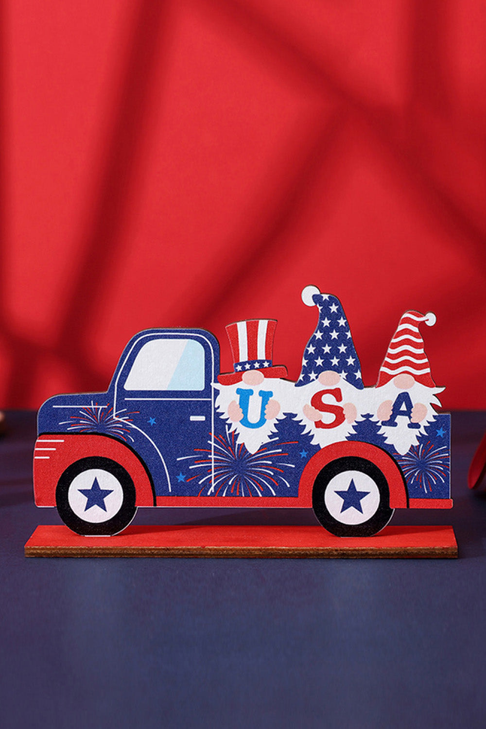 Patriotic wood block decor truck with gnomes spelling USA, red, white, and blue.