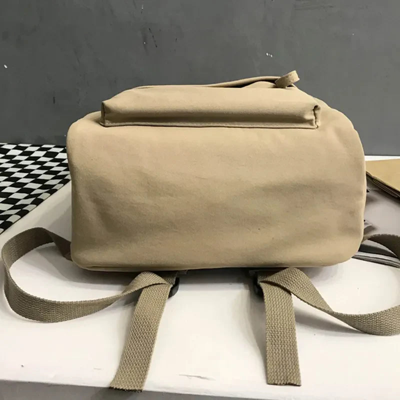 Khaki canvas backpack with dual pockets and adjustable straps