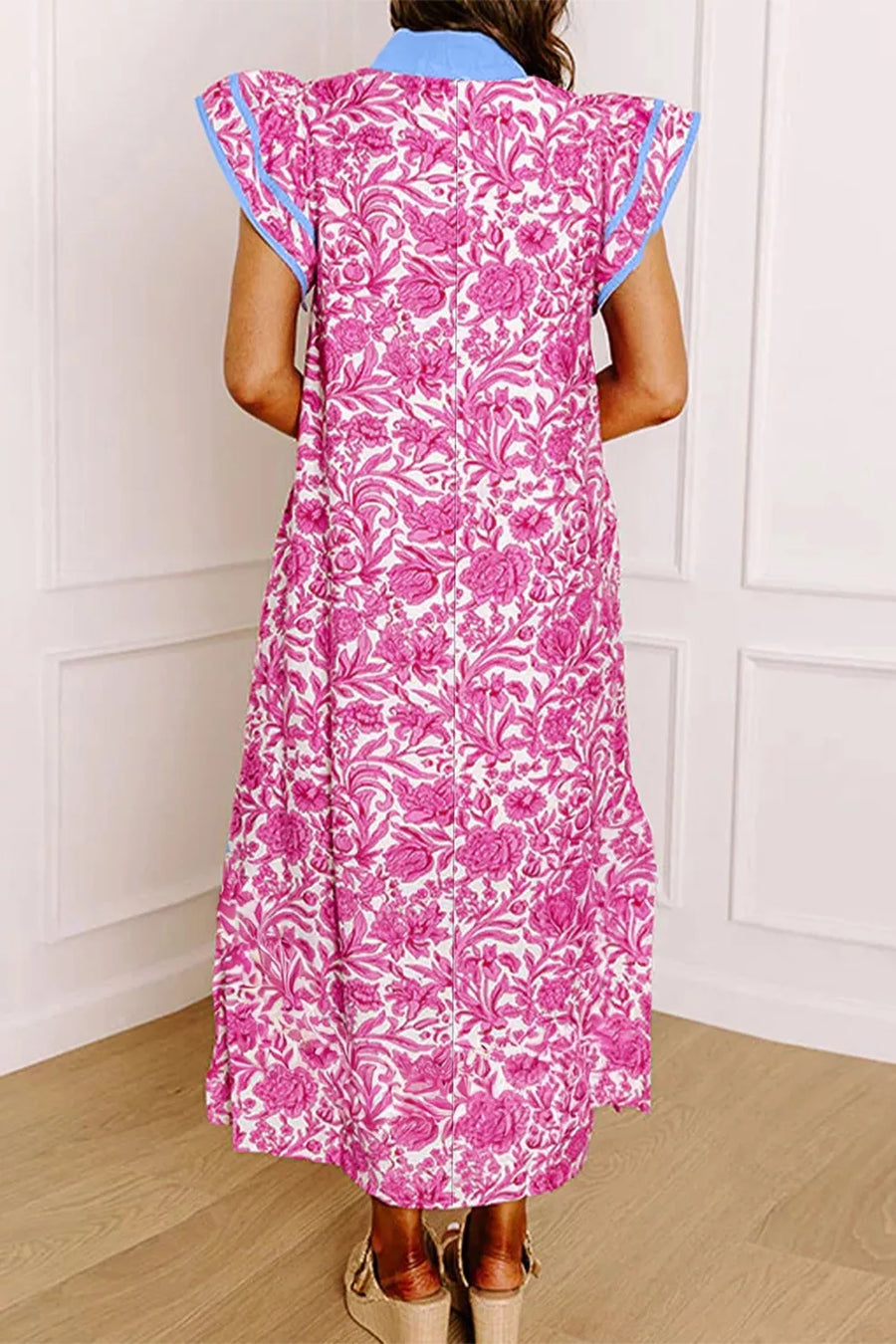 Midi dress with vibrant pink floral print, ruffle sleeves, and blue trim.