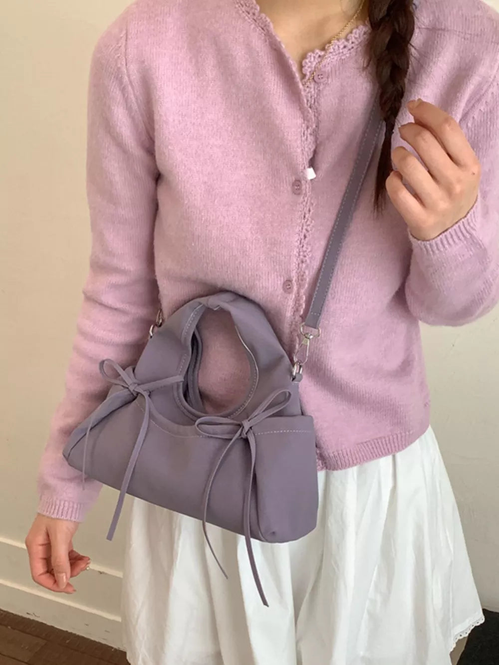 crossbody bag in lavender featuring bow details and straight fit