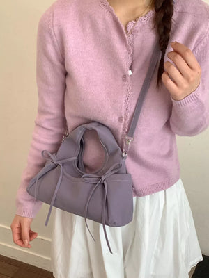 crossbody bag in lavender featuring bow details and straight fit