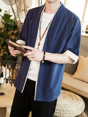 Navy contrast trim half sleeve shirt with white cuffs, worn open over a white tee.