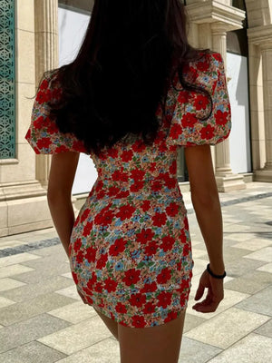 Red floral print mini dress with puff sleeves and ruched detailing.