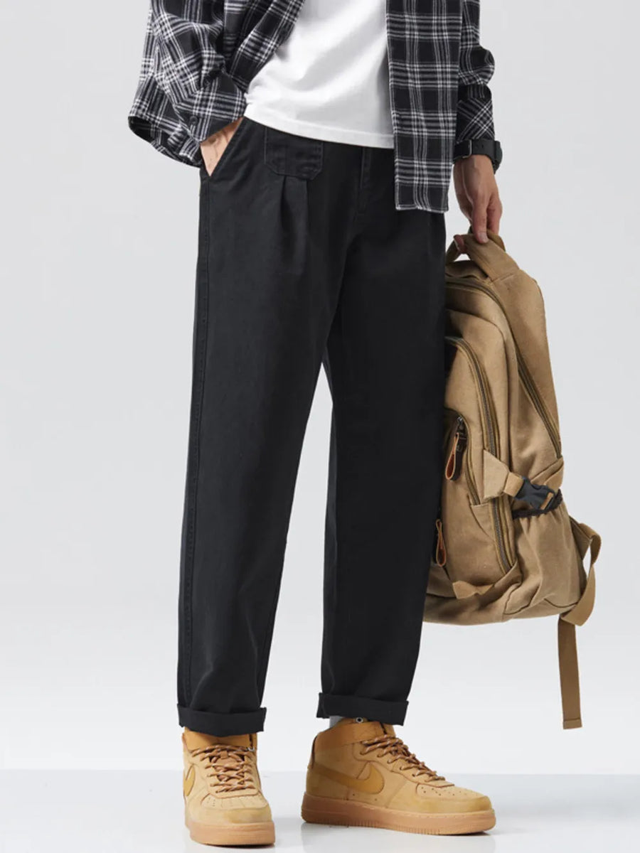 Men's black relaxed fit sweatpants with pockets and cuffed ankles.