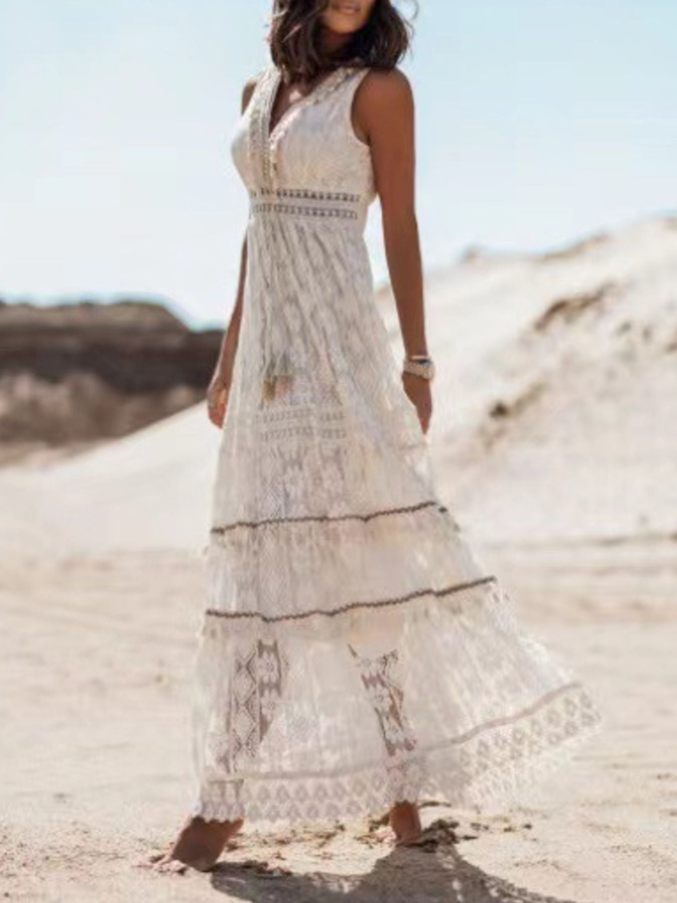 White lace V-neck maxi dress with tiered skirt and crochet details.