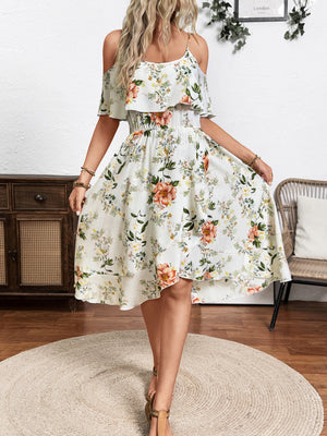 Floral print cold shoulder dress with ruffled overlay and smocked waist.