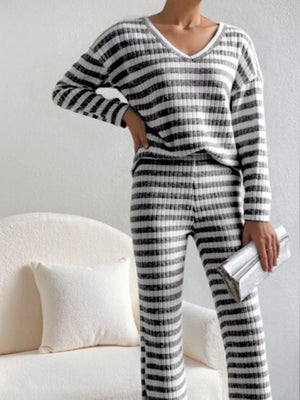 Black striped knit loungewear set with v-neck top and pants.