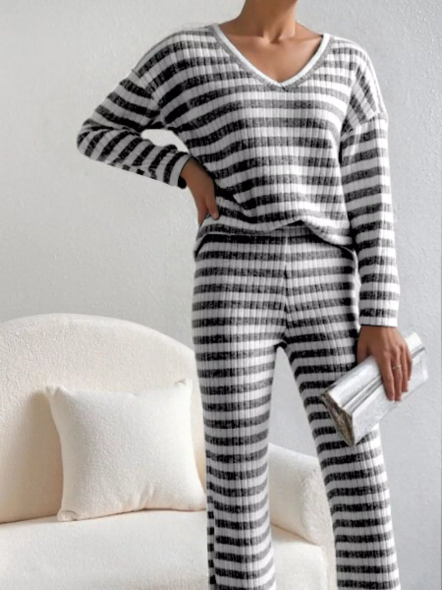 Black striped knit loungewear set with v-neck top and pants.