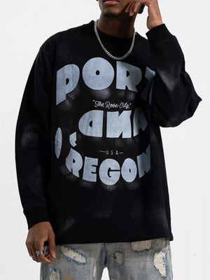 Black oversized long-sleeve tee with bold "PORTLAND OREGON" graphic and "The Rose City" detail.