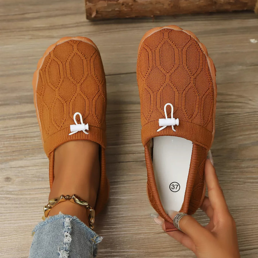 White flats featuring round toe and geometric