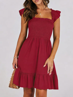 Burgundy smocked ruffle hem mini dress with square neckline and flutter sleeves.