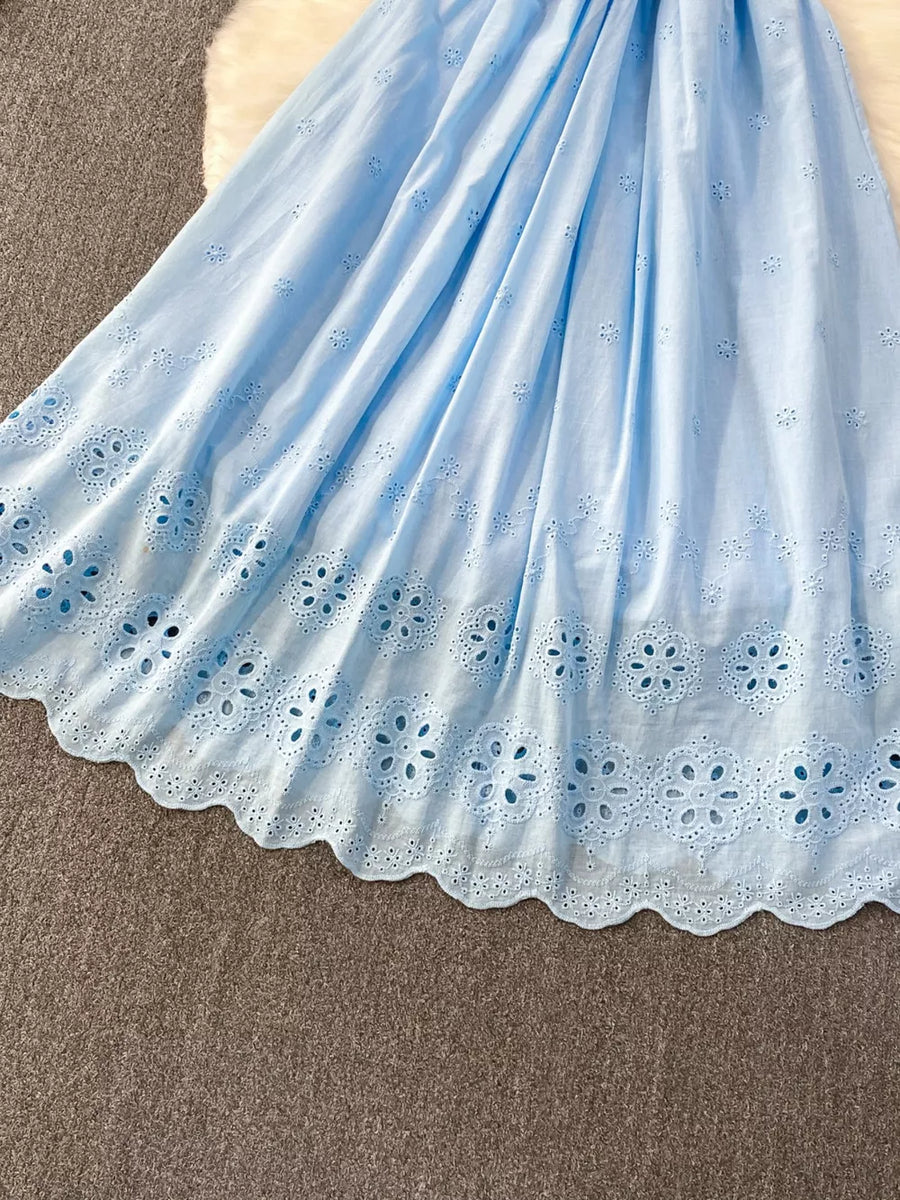 Blue eyelet maxi dress with floral cutout hem detail