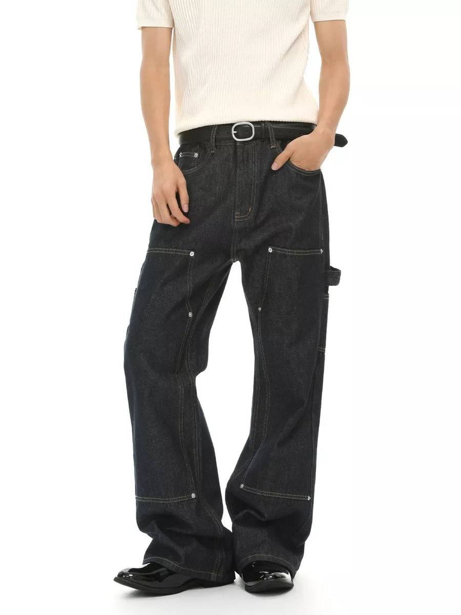 Dark wash cotton blend carpenter jeans with contrast stitching and distinctive pockets.