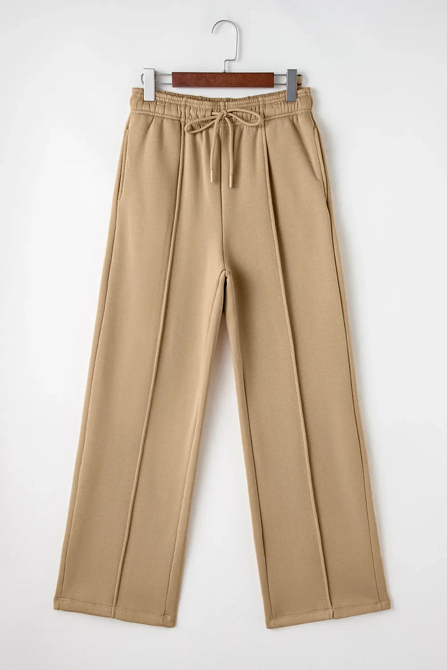 Tan wide-leg sweatpants with relaxed seam detail and drawstring waist.