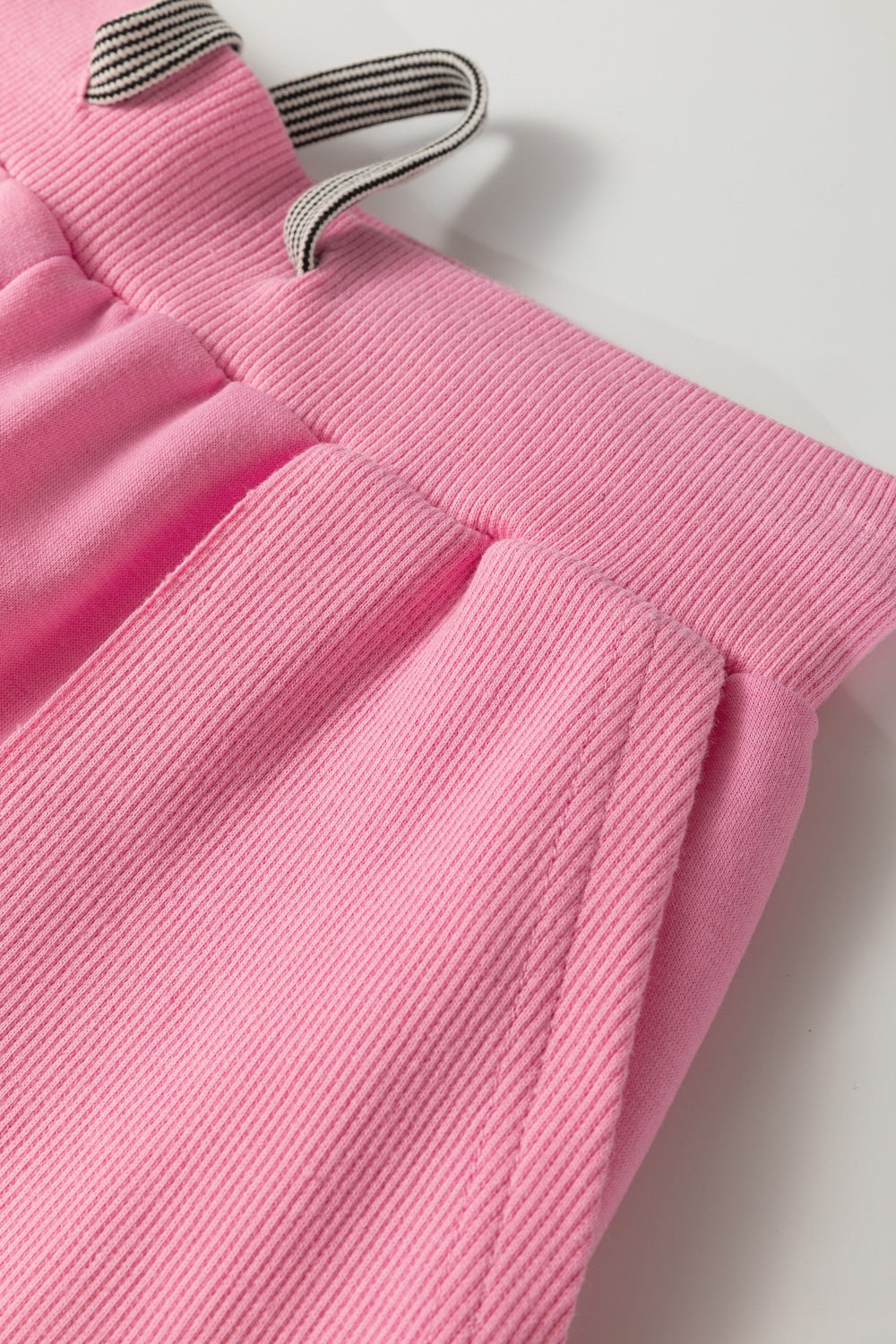 Pink cotton loungewear pants with drawstring and ribbed waistband detail